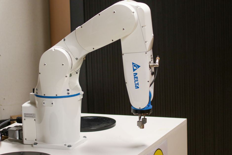 Automated robotic arm representing semiconductor and AI infrastructure investment