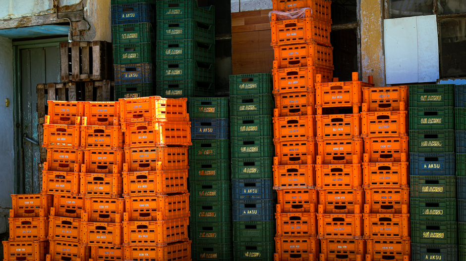Crate and warehouse logistics show how physical inventory carries tariff and freight exposure.