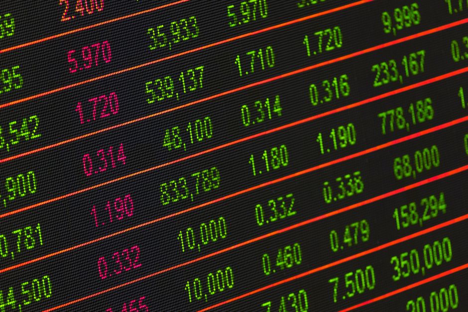 Digital stock exchange board displaying financial market data and price movements.