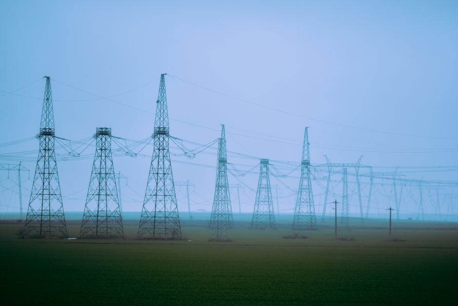 Electric transmission towers represent the power infrastructure required to expand AI data-center capacity.