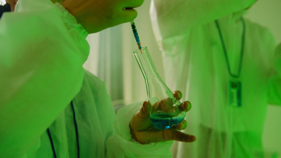 Scientist handling a laboratory sample during biotech research