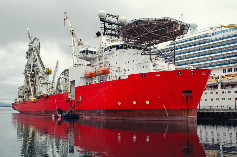 An oil tanker docked at a harbor.