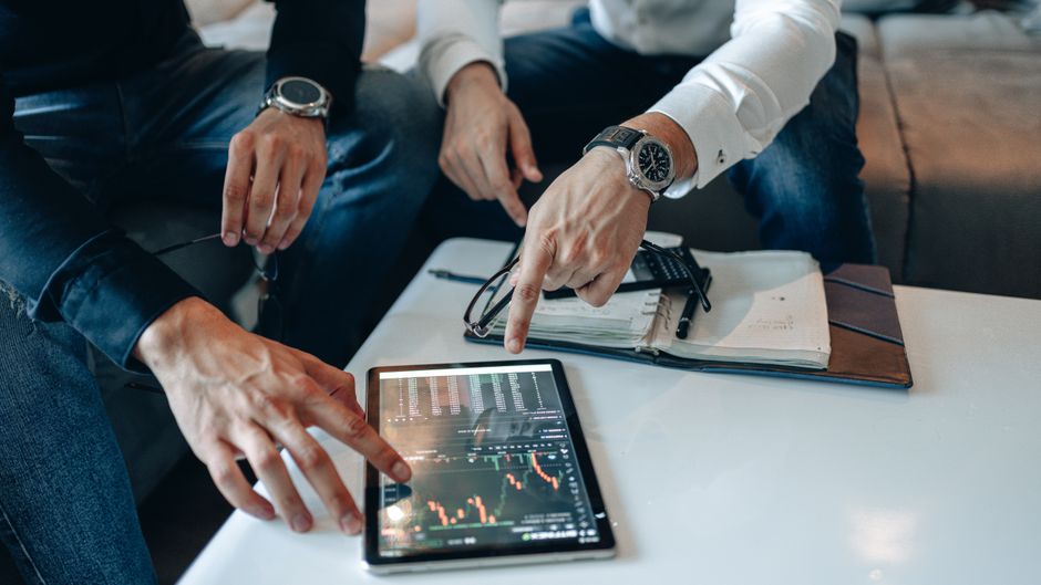 Market professionals review financial data as the post-holiday IPO pipeline meets public-market capacity.