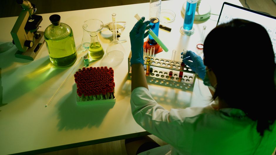 Researcher examining vials in a pharmaceutical laboratory
