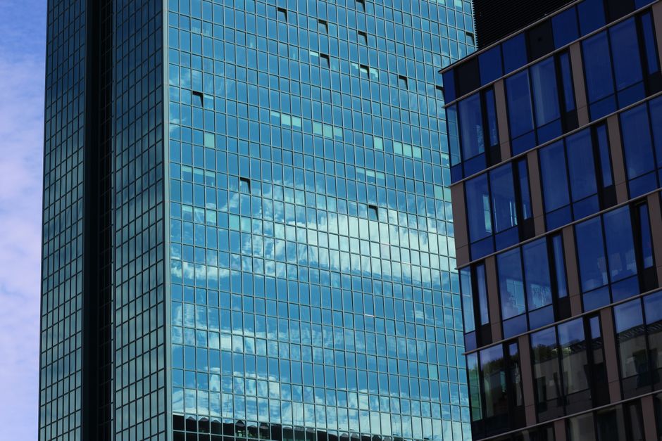 High-rise building with reflective glass windows showcasing a modern architectural style.