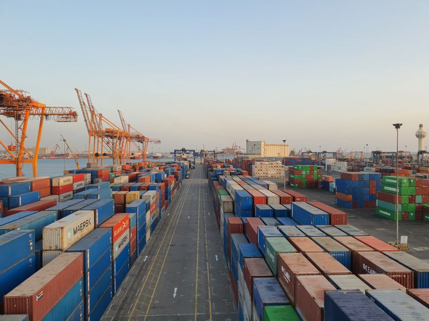 Cargo containers stacked in a bustling harbor
