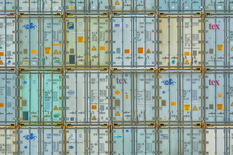 Stacked shipping containers at an industrial port
