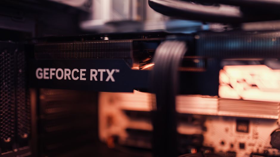 Close-up view of a GeForce RTX graphics card installed in a computer, showing the GPU circuitry and cooling system.