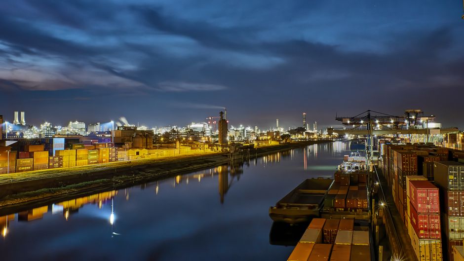 A lit commercial port and waterway represent the freight infrastructure exposed to a developing Gulf supply shock.
