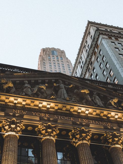 The New York Stock Exchange building facade in the financial district at dusk