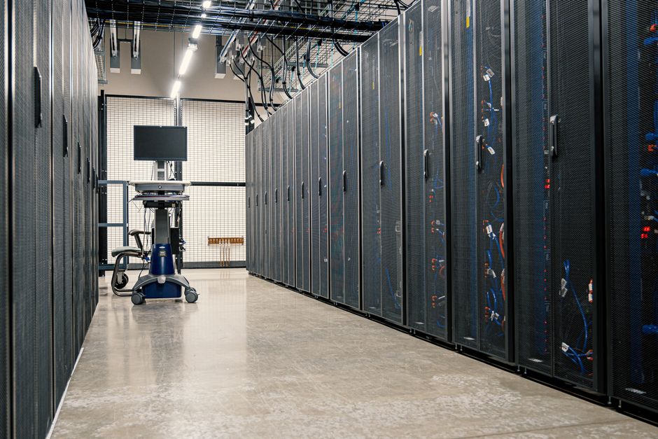 Rows of illuminated server racks in a data center.