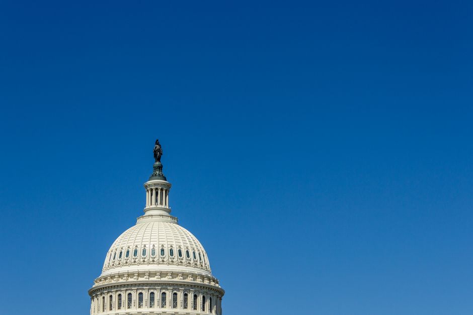 The US Capitol Dome in Washington, DC, with a clear blue sky behind it