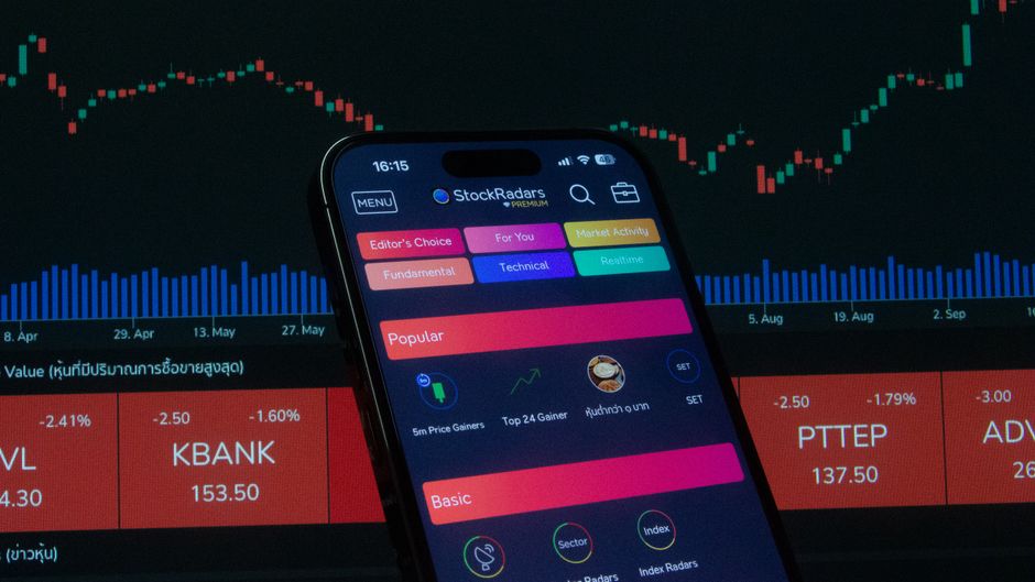 A stock trading application and market charts represent public-market issuance and the challenge of absorbing new supply.