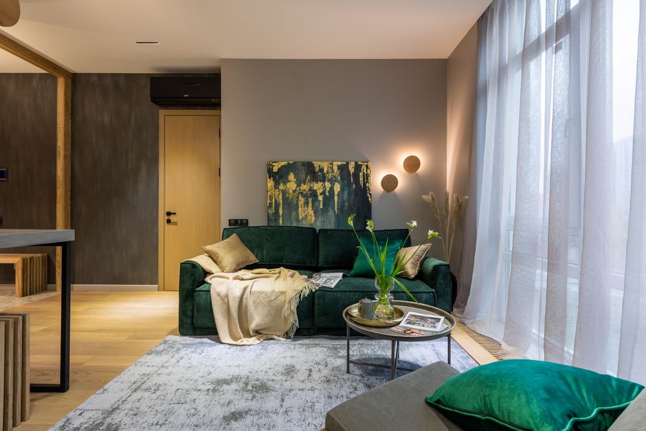 A stylishly furnished living room with a comfortable sofa and modern decor.