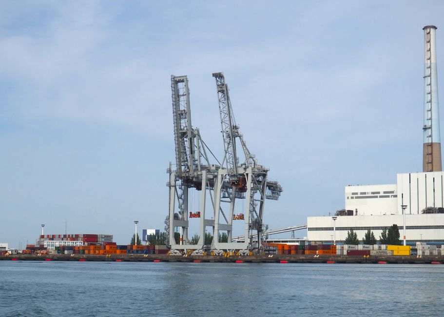Container terminal gantry cranes at a major seaport, representing the global shipping infrastructure under strain from Middle Eastern waterway disruptions and trade sanctions.