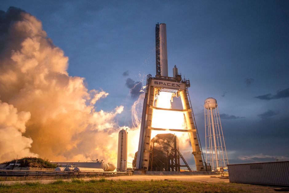 A SpaceX rocket ascending against a colorful dusk sky, symbolizing the scale of the company's public market debut.