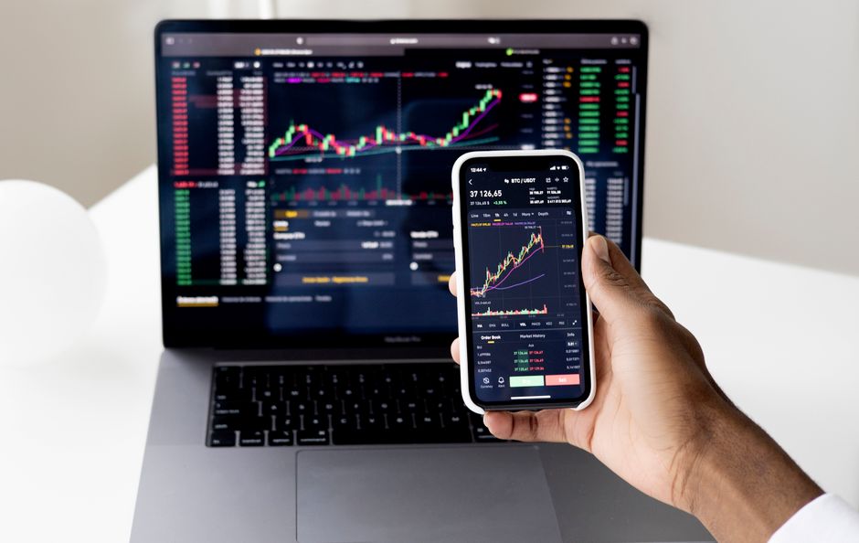 A trader reviews market data as new public-market issuance tests liquidity and order-book depth.