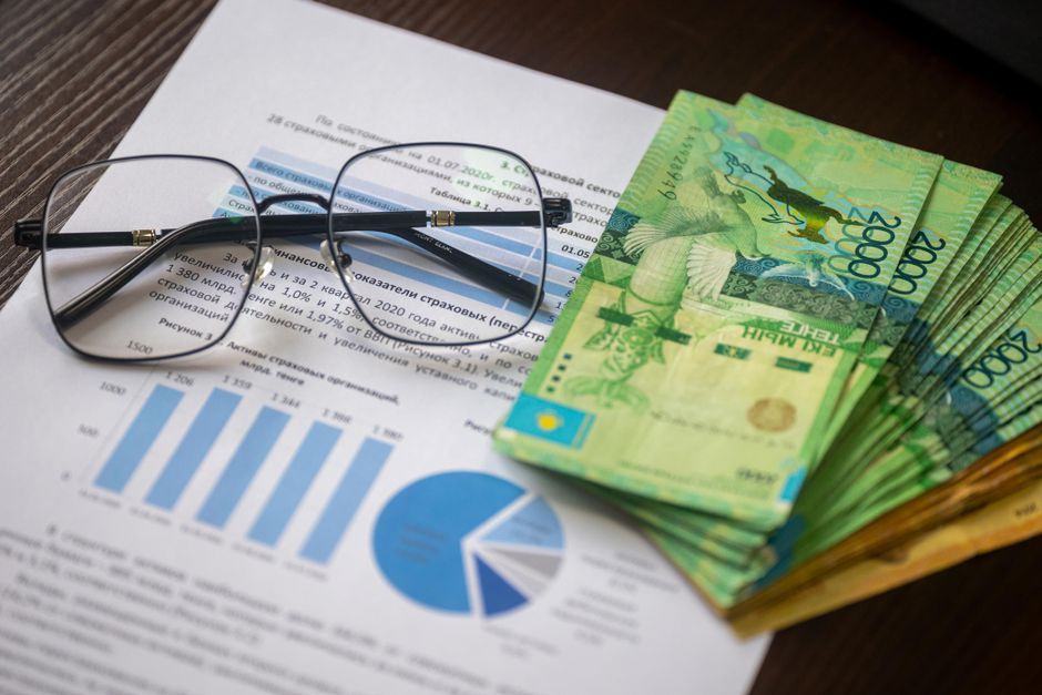 Financial reports and currency rest on a desk as public-market supply is assessed