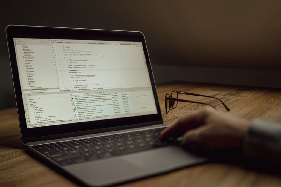 A developer works on cloud software code, representing enterprise technology demand.