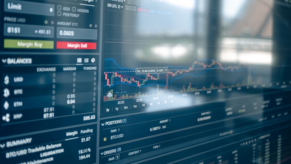 Stock exchange charts and market data displayed on a digital screen