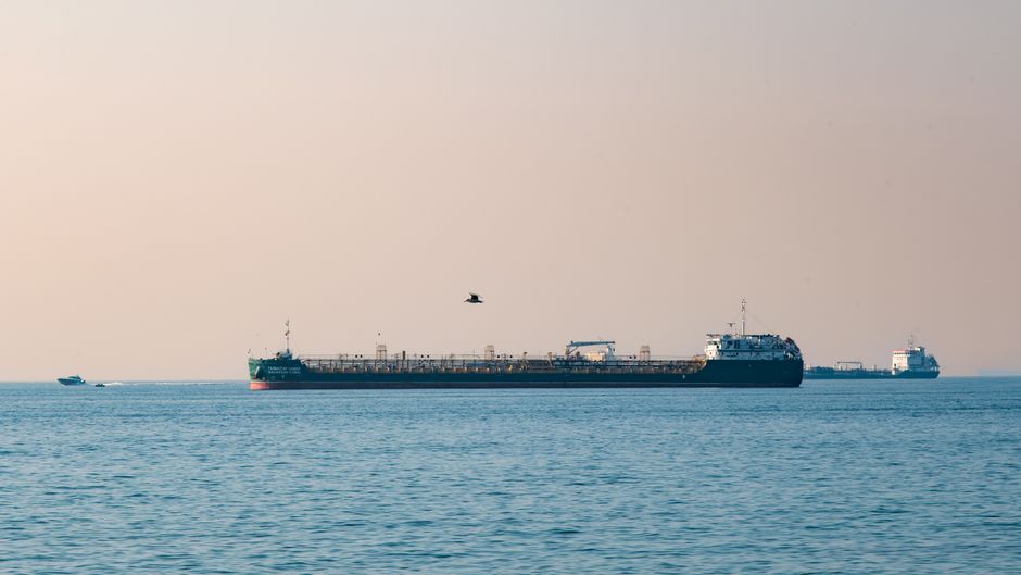 Cargo ships navigating open water along a major energy shipping route