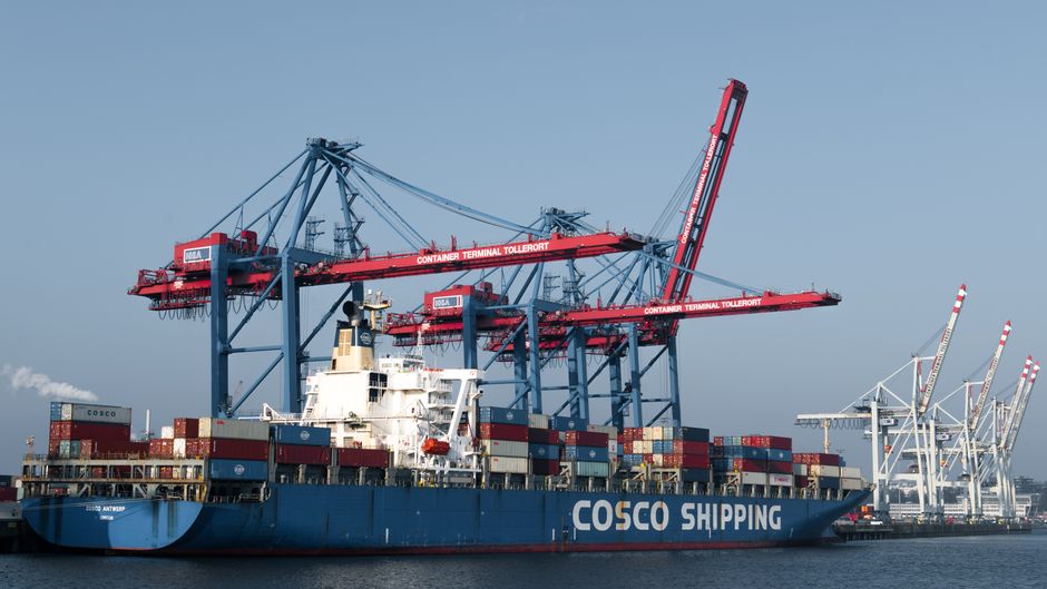 Cargo ship docked at a commercial port terminal as shipping risks lift energy prices.