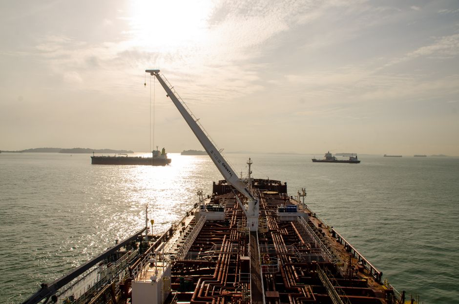 A cargo ship sails through open water as shipping disruption raises freight and energy risk.