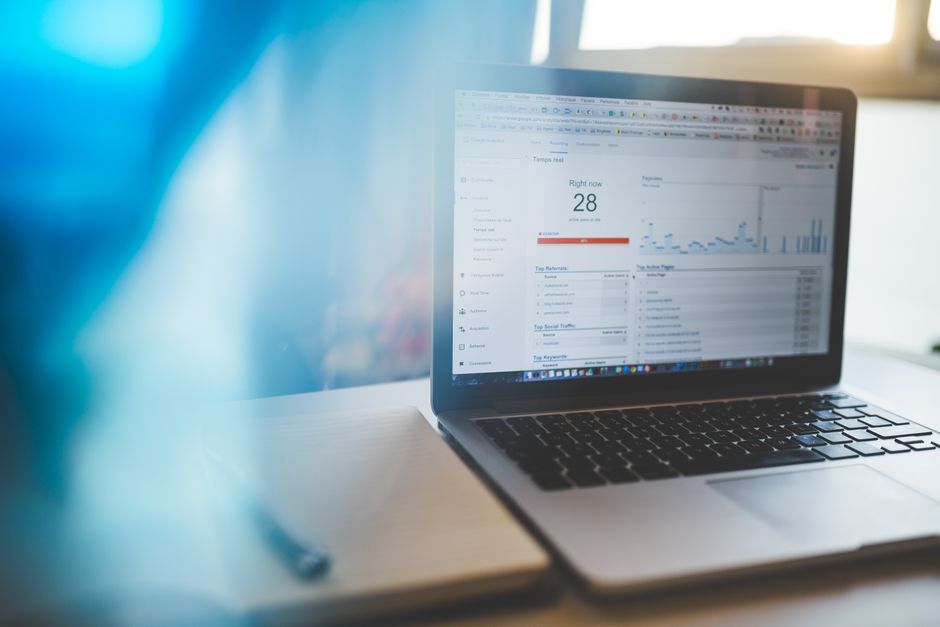 A laptop displays analytics software in a modern workspace, reflecting enterprise demand for cloud data and AI operations.