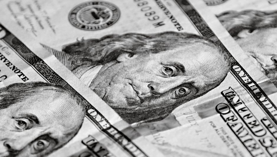 A close-up of U.S. dollar bills representing capital raising and liquidity