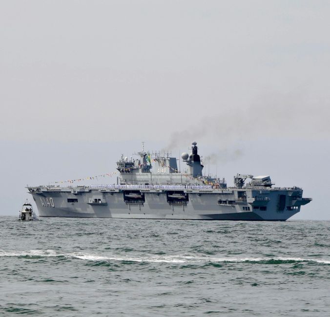 Military aircraft carrier sailing on open ocean
