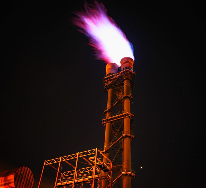 Industrial gas flare at night