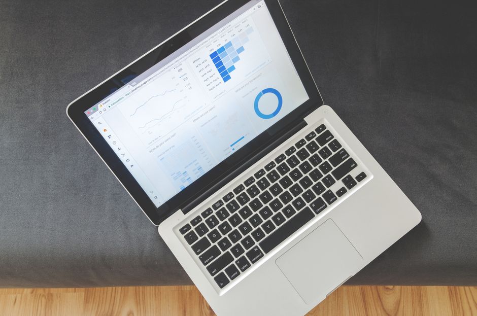 A laptop displays data visualizations representing software usage and cloud demand.
