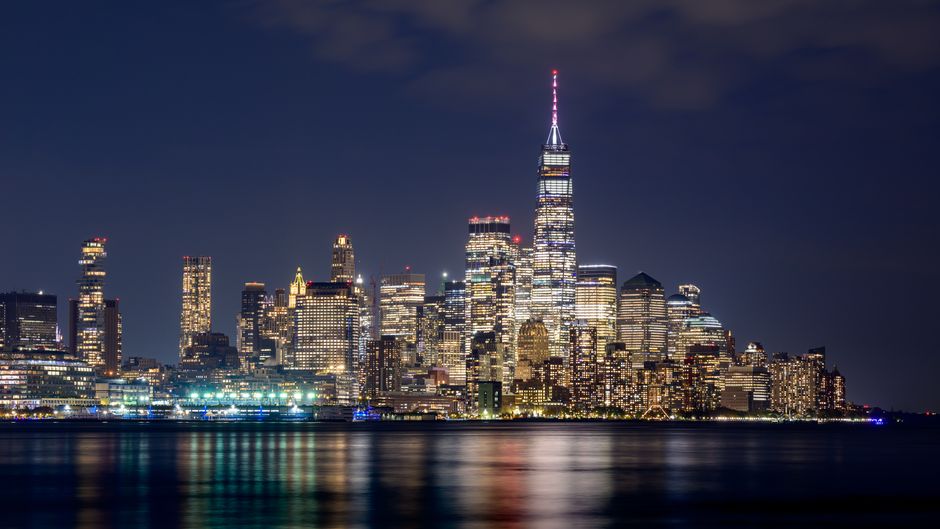 New York City skyline viewed across the water at night, representing the financial markets backdrop for the bond-yield and equity-rotation story.