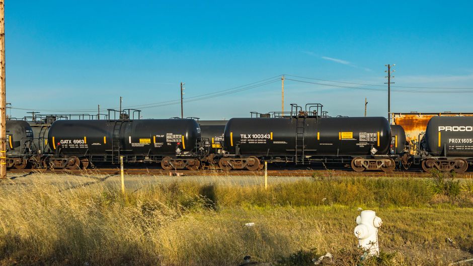 Black fuel tank cars on a railway, representing the diesel logistics chain affected by the Hormuz energy shock.