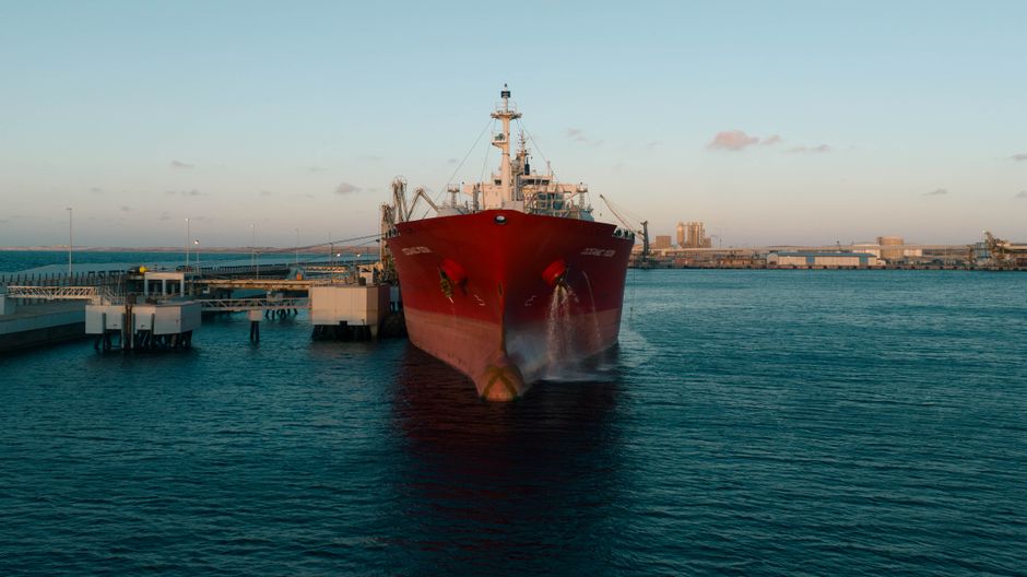 A cargo ship at an industrial port represents the freight and energy costs reaching home-furnishings margins.