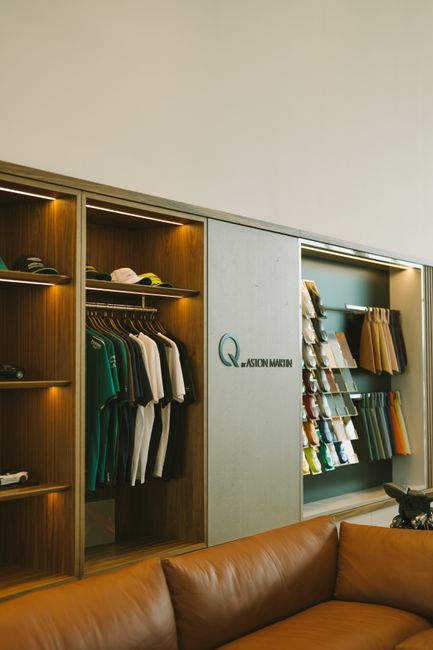 Luxury clothing and accessories arranged in a high-end retail wardrobe