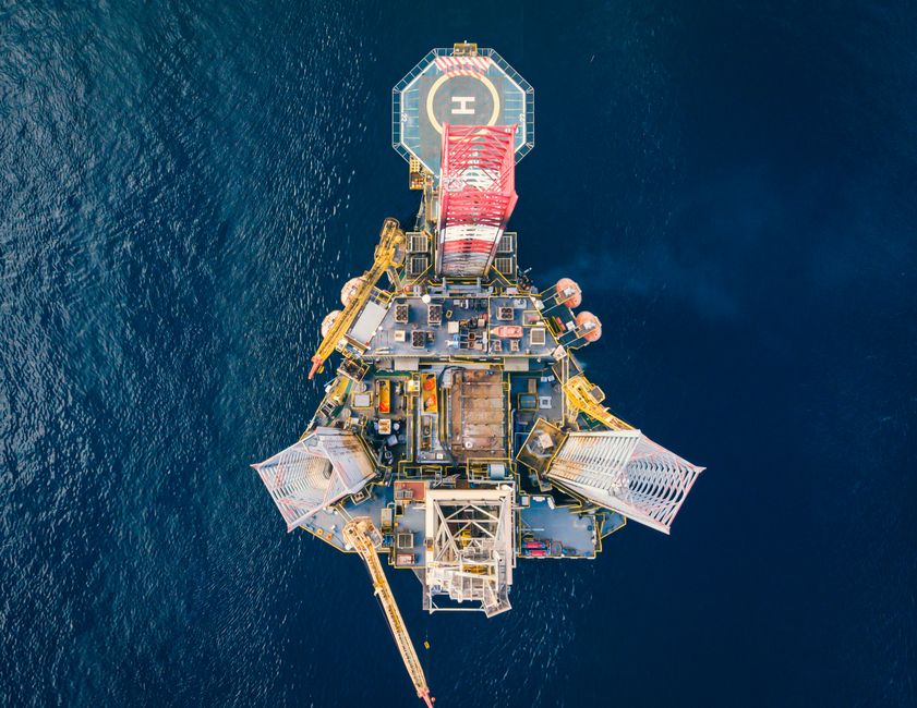 Offshore oil platform with helipad surrounded by ocean