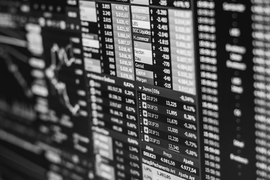 Monochrome stock-market data displayed on a screen representing public-market price discovery