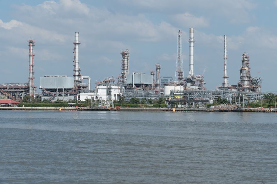 A large oil refinery complex next to the water.