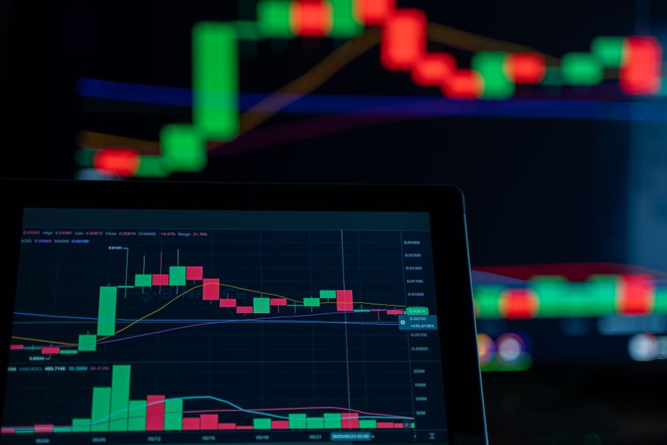 Close-up of a digital trading chart with candlestick patterns and market analysis in a dark setting