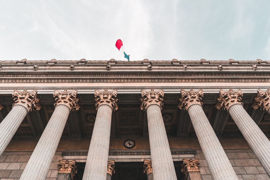 Majestic columns of a classical government building, symbolizing regulatory institutions.