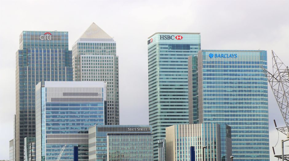 Modern financial-district buildings representing the institutions and intermediaries involved in equity issuance