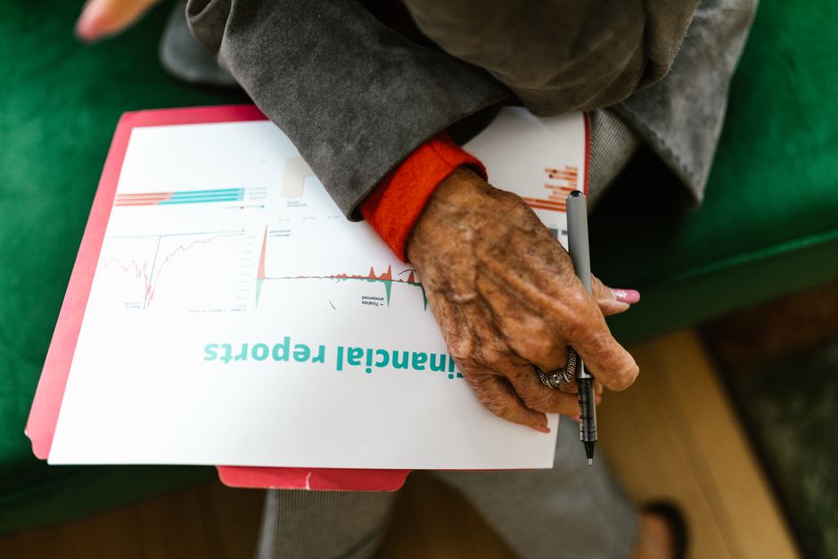 A financial report being reviewed with a pen