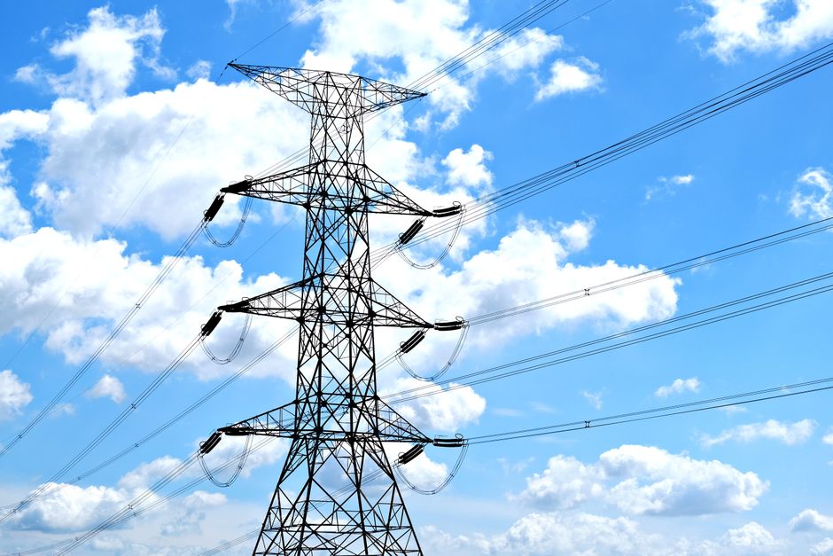 Electricity transmission towers represent the grid capacity needed to turn AI demand into operating infrastructure.