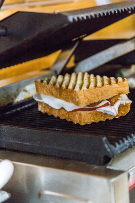 A grilled cheese sandwich being cooked on a panini press