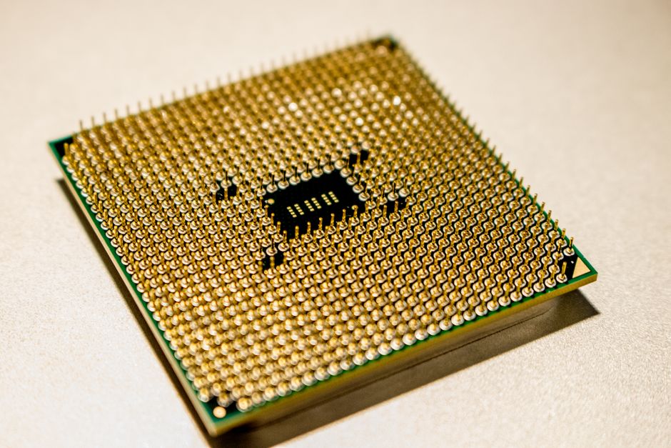 Detailed close-up of a golden microprocessor chip, ideal for technology concepts.