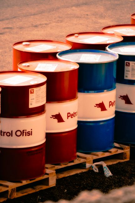 Red and blue oil barrels in an outdoor industrial setting