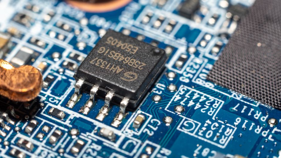 A microchip represents the semiconductor infrastructure behind the AI demand debate.