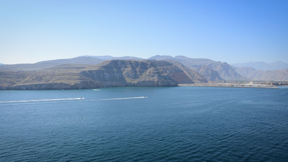 Panoramic view of the Musandam Peninsula coastline in Oman, overlooking the Strait of Hormuz shipping lane.