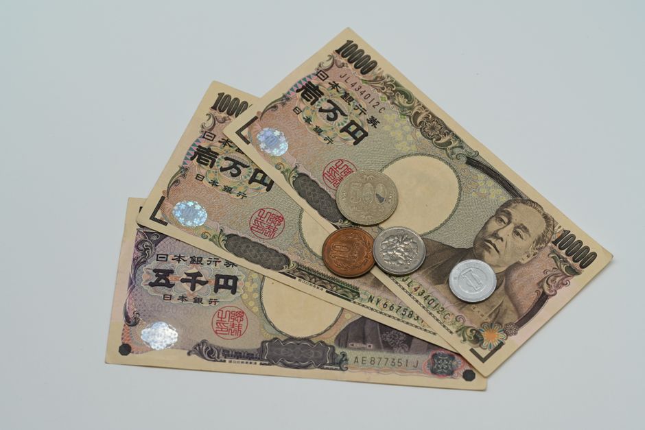 Japanese yen banknotes and coins arranged on a flat surface